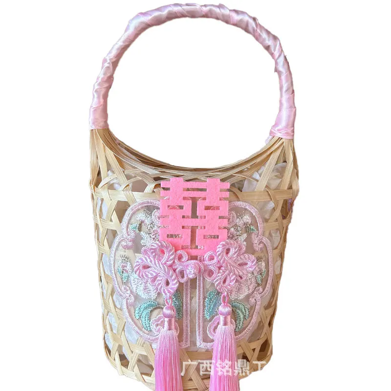 Open-Lattice Cylindrical Favor Basket — Open cylindrical basket with lattice weaving, wrapped handle and hanging decorative accents, designed for compact favors and welcome gifts.