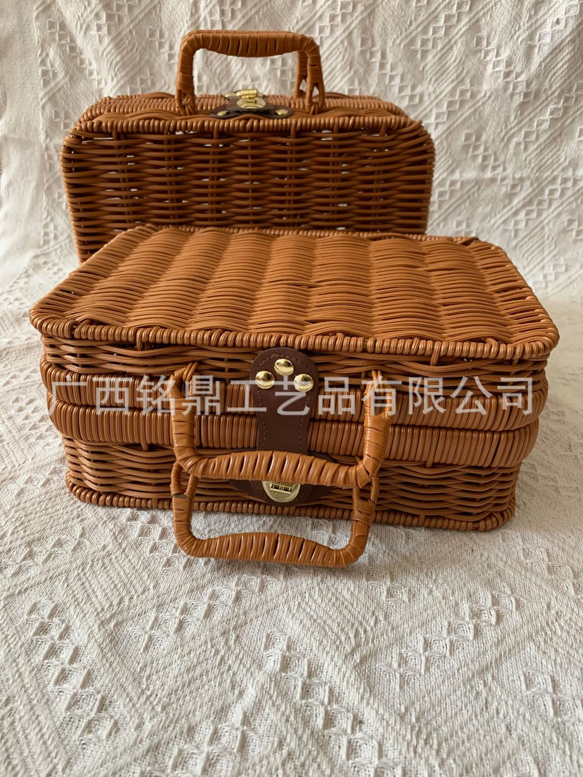 Woven carry cases showing lid, handles and clasp